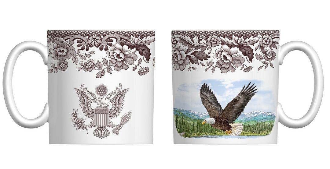 Two mugs with decorative designs of an eagle and floral patterns on a white background