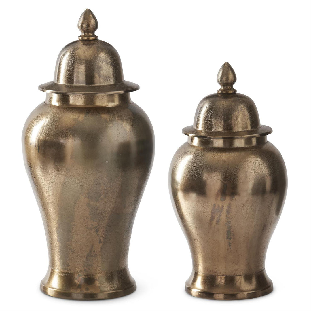 Two brass urns with domed lids on a white background