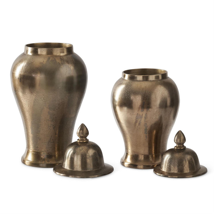 Set of three bronze urns with lids on a white background