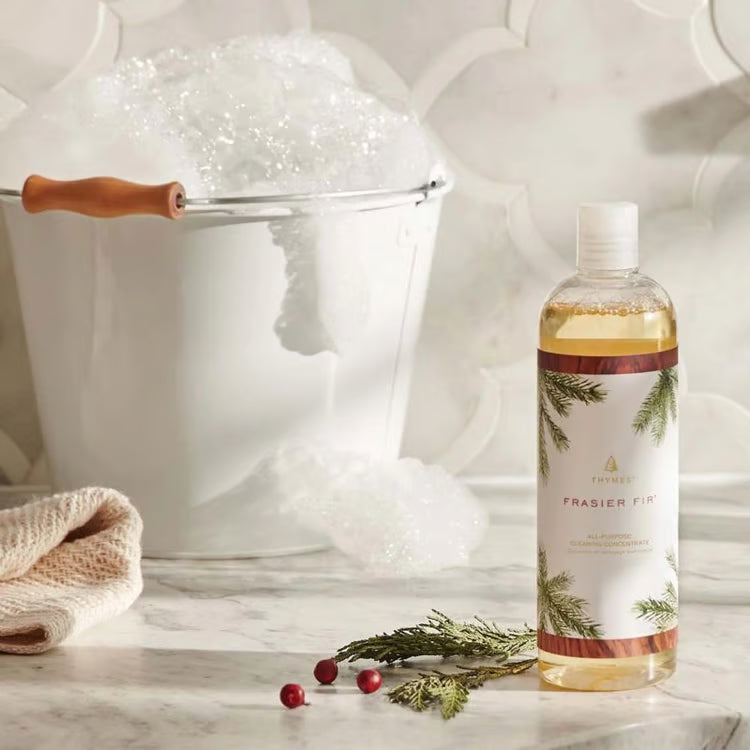 Bottle of Frasier Fir cologne with decorative elements on a marble surface.