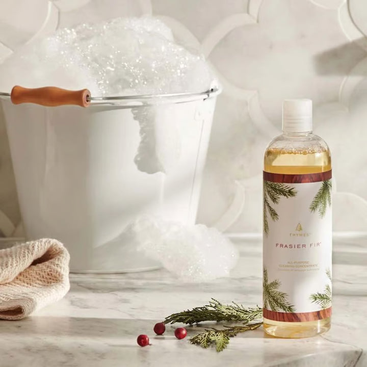 Bottle of Frasier Fir cologne with decorative elements on a marble surface.