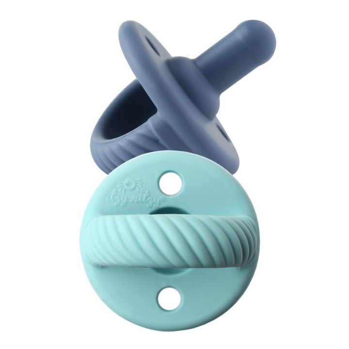 Two blue pacifiers on a white background