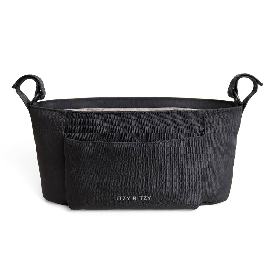 A black structured baby carrier insert with two top handles and a front pocket, featuring the brand name 'ITZY RITZY' printed in white near the bottom center, set against a plain white background.