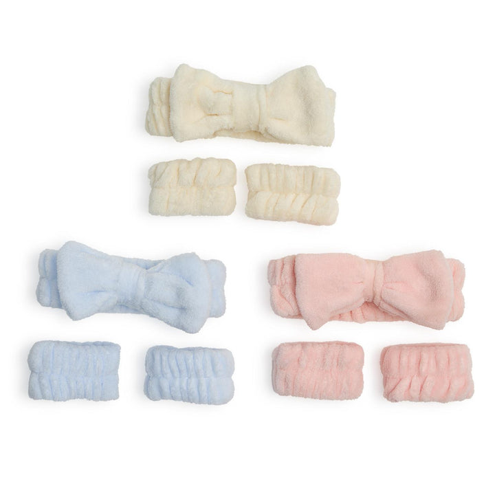 Set of baby headbands and booties in white, blue, and pink on a white background