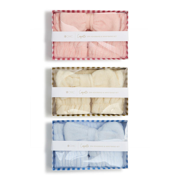 Three packages of baby blankets in pink, white, and blue with checkered patterns on a white background.