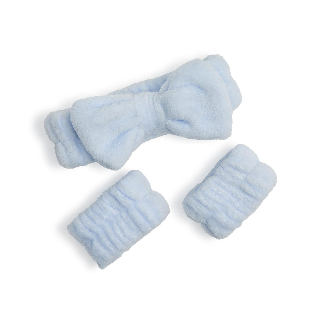 Set of light blue baby socks and booties on a white background
