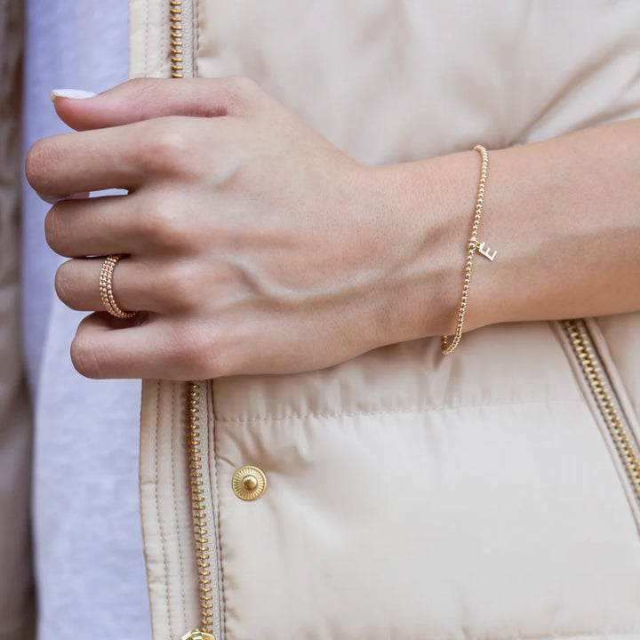 A beautiful, simple piece reminding us of who we are and to celebrate each other. Enjoy your own initial and those of whom you love.

Made with 2mm, 14kt gold-filled beads, 14kt gold-filled letter charm