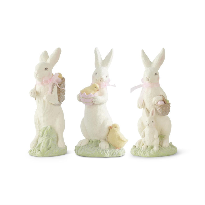 Three decorative rabbit figurines with chicks on a white background