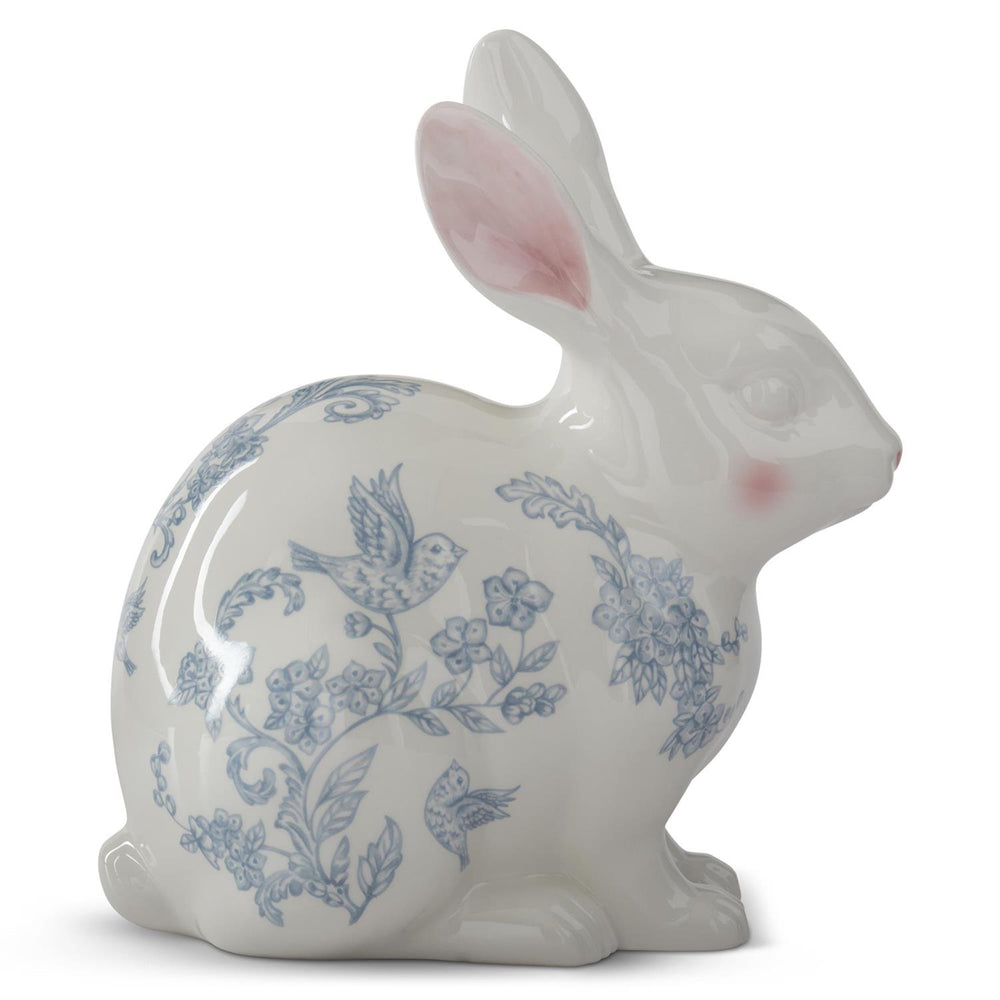 Ceramic rabbit figurine with blue floral and bird pattern on a white background