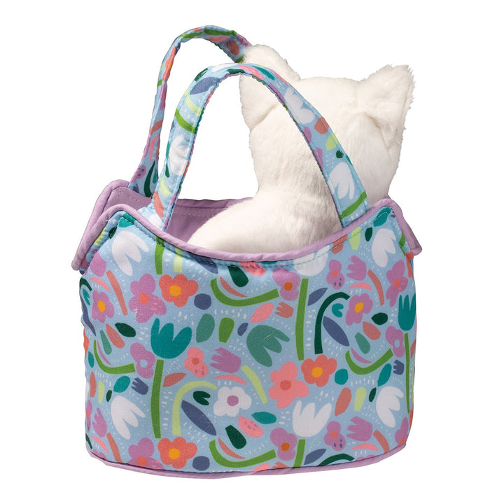 WHITE CAT IN A FLORAL AND BLUE PLAY SACK ON WHITE BACKGROUND