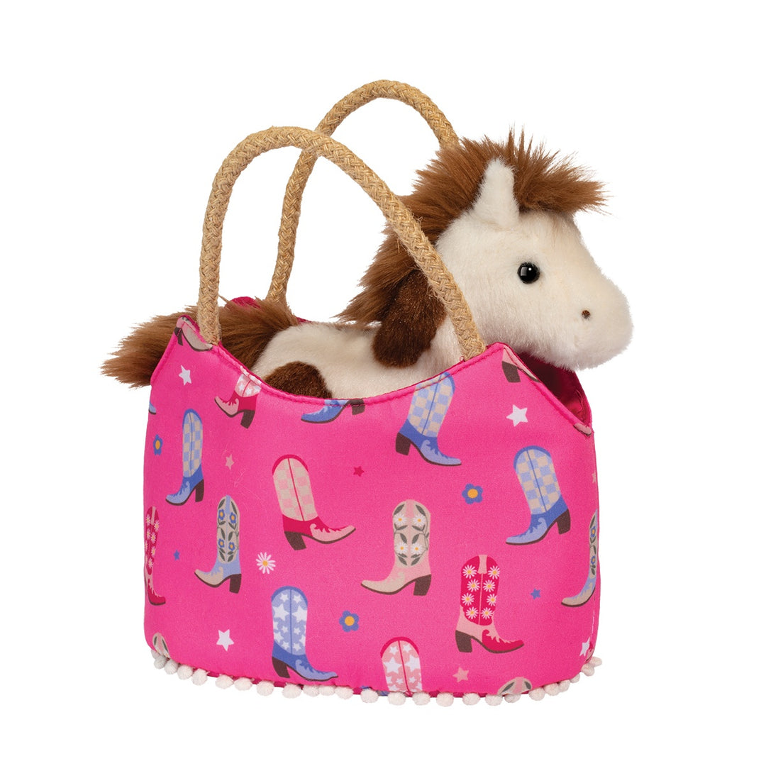 Pink cowboy boot tote bag with rope handles and white pom-pom trim, featuring a plush brown and white horse toy peeking out from the top | Walker Boutique