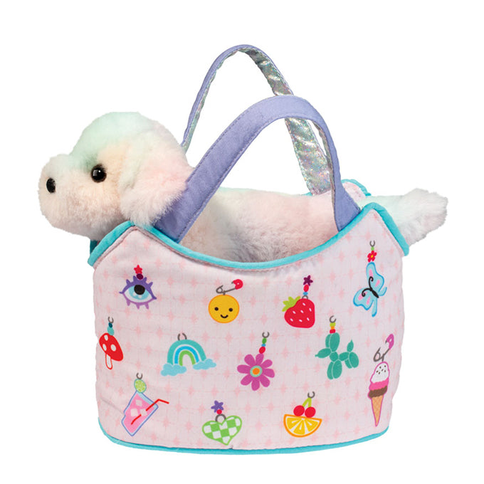 Pastel puppy plush toy tucked inside a pink charm-print tote bag with lavender handles, featuring colorful icons including butterflies, rainbows, fruit, flowers, and ice cream | Walker Boutique