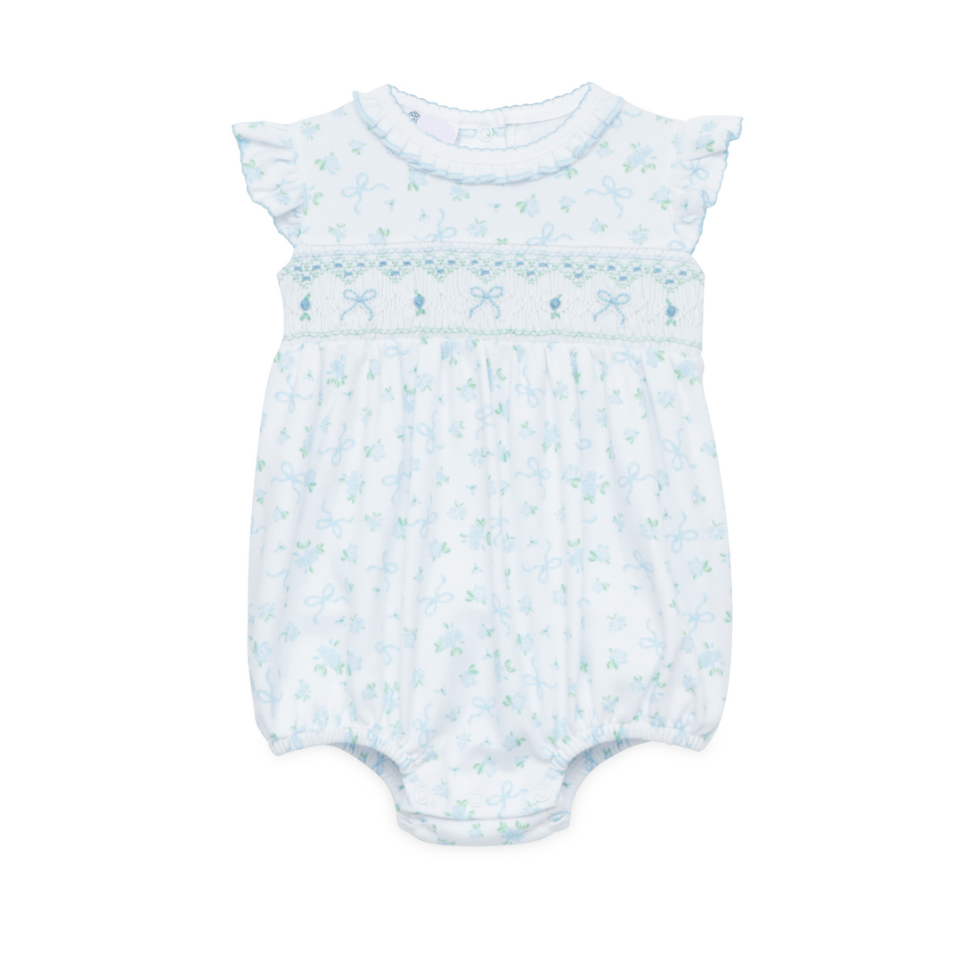 WHITE SMOCKED BUBBLE WITH FLUTTER SLEEVES AND ALL OVER BLUE AND GREEN BOW DESIGN