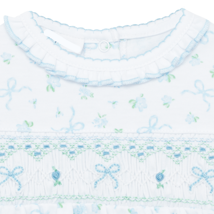 WHITE SMOCKED BUBBLE WITH FLUTTER SLEEVES AND ALL OVER BLUE AND GREEN BOW DESIGN