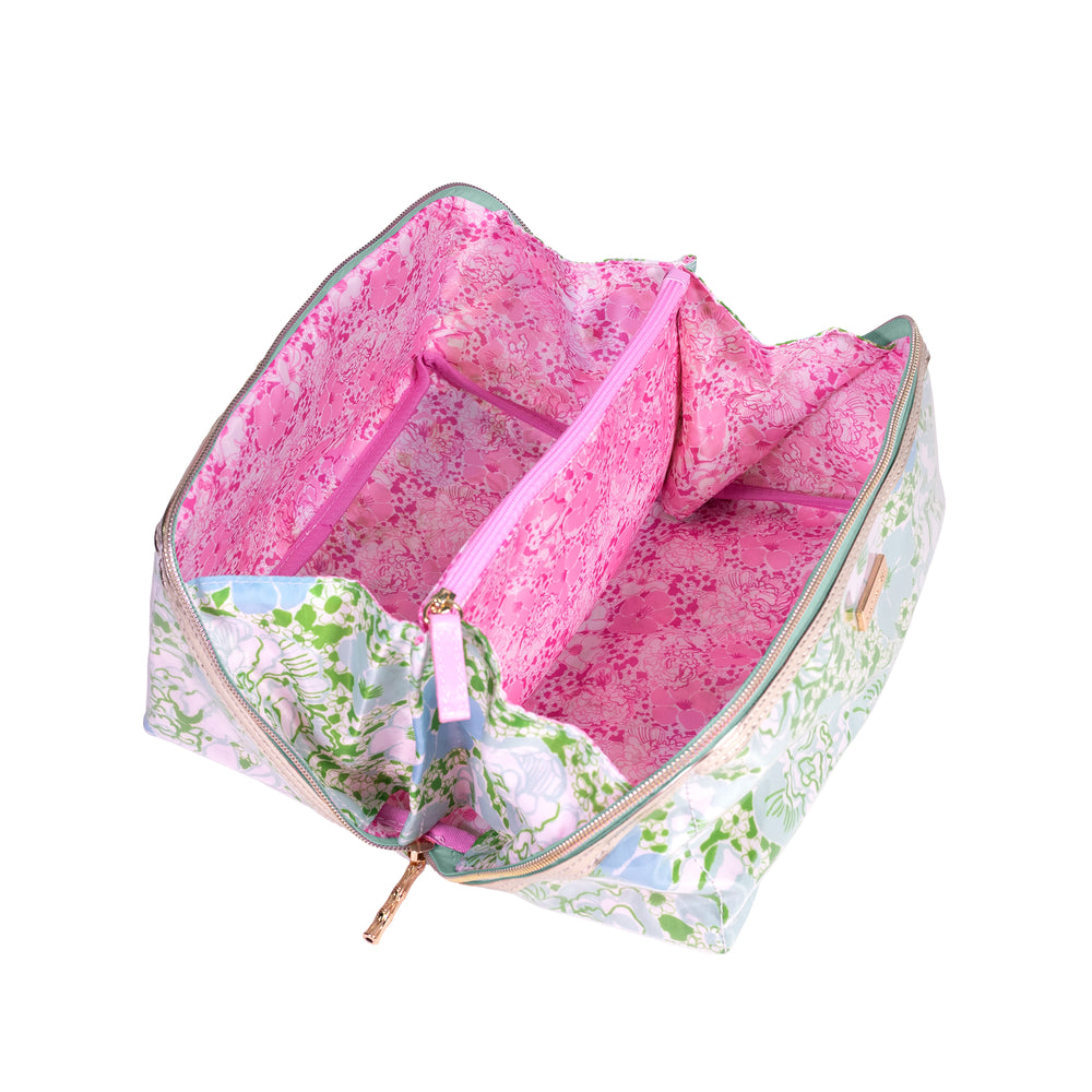 Floral-patterned bag with a pink interior on a white background