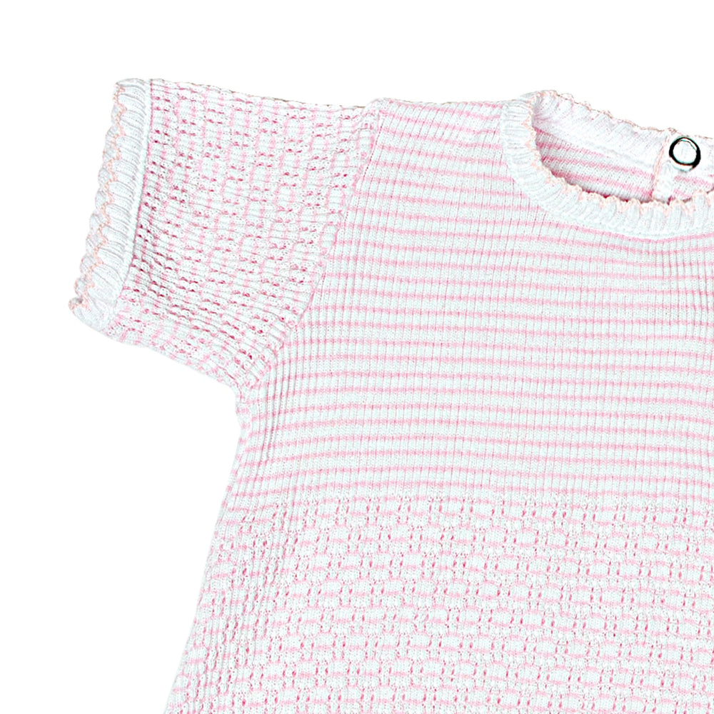 Close-up of a pink and white textured dress on a white background