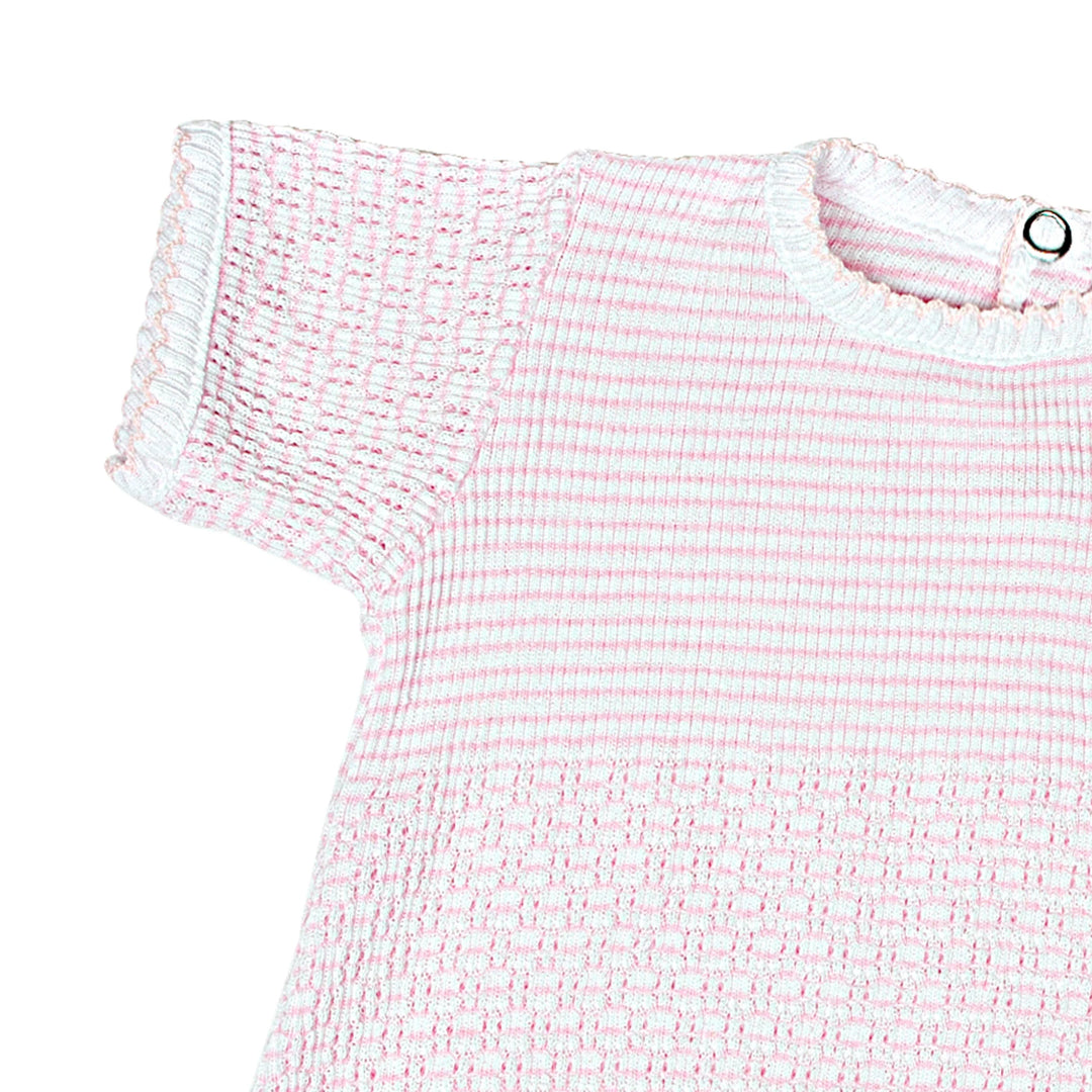 Close-up of a pink and white textured dress on a white background