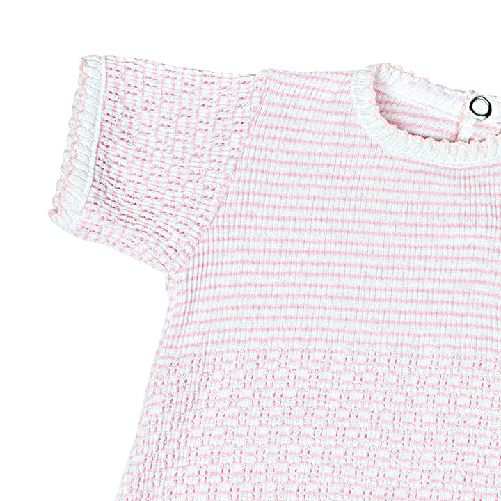 Close-up of a pink and white textured dress on a white background