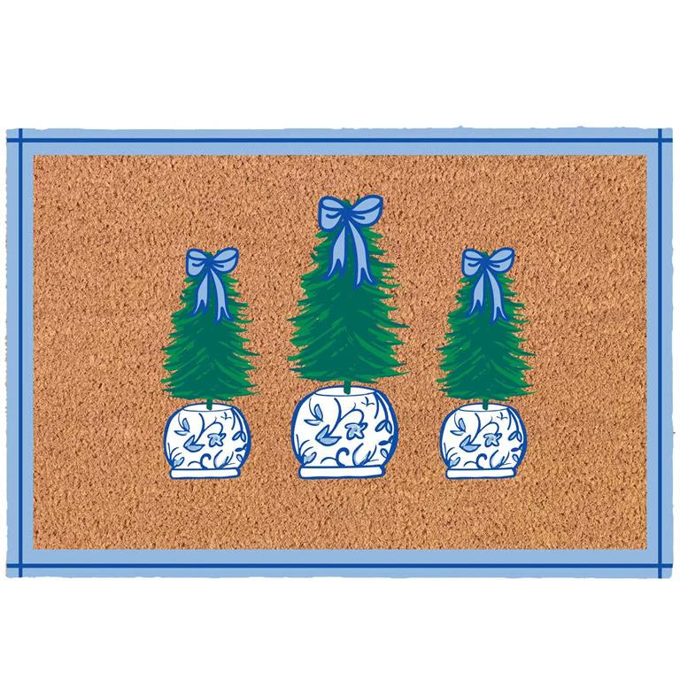 Doormat with decorative Christmas trees and blue ribbons on a brown background