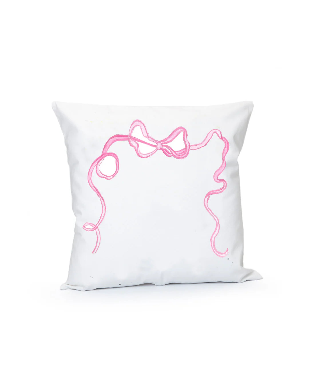 White pillow with pink decorative bow design on a white background