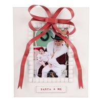 Gift box with a photo of a child and a person, tied with a red ribbon, on a white background.