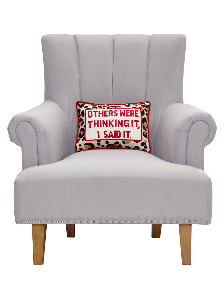 CHEETAH PRINT EMBROIDERED PILLOW WITH OTHERS WERE THINKING IT, I SAID IT STITCHED IN RED STYLED ON CHAIR