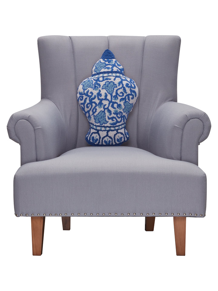 STYLED SHOT OF CHINOISERIE VASE SHAPED PILLOW ON GRAY CHAIR