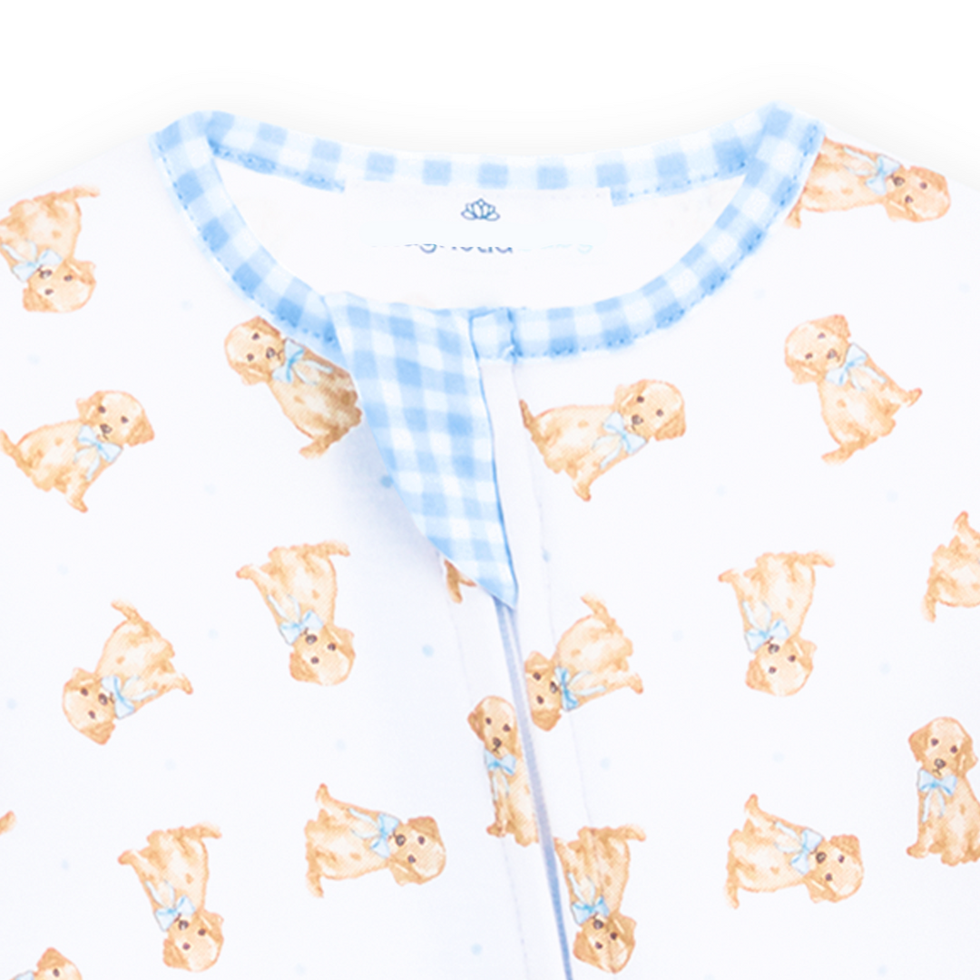Allover golden puppy print on a white background with classic blue gingham trim footie with long sleeves