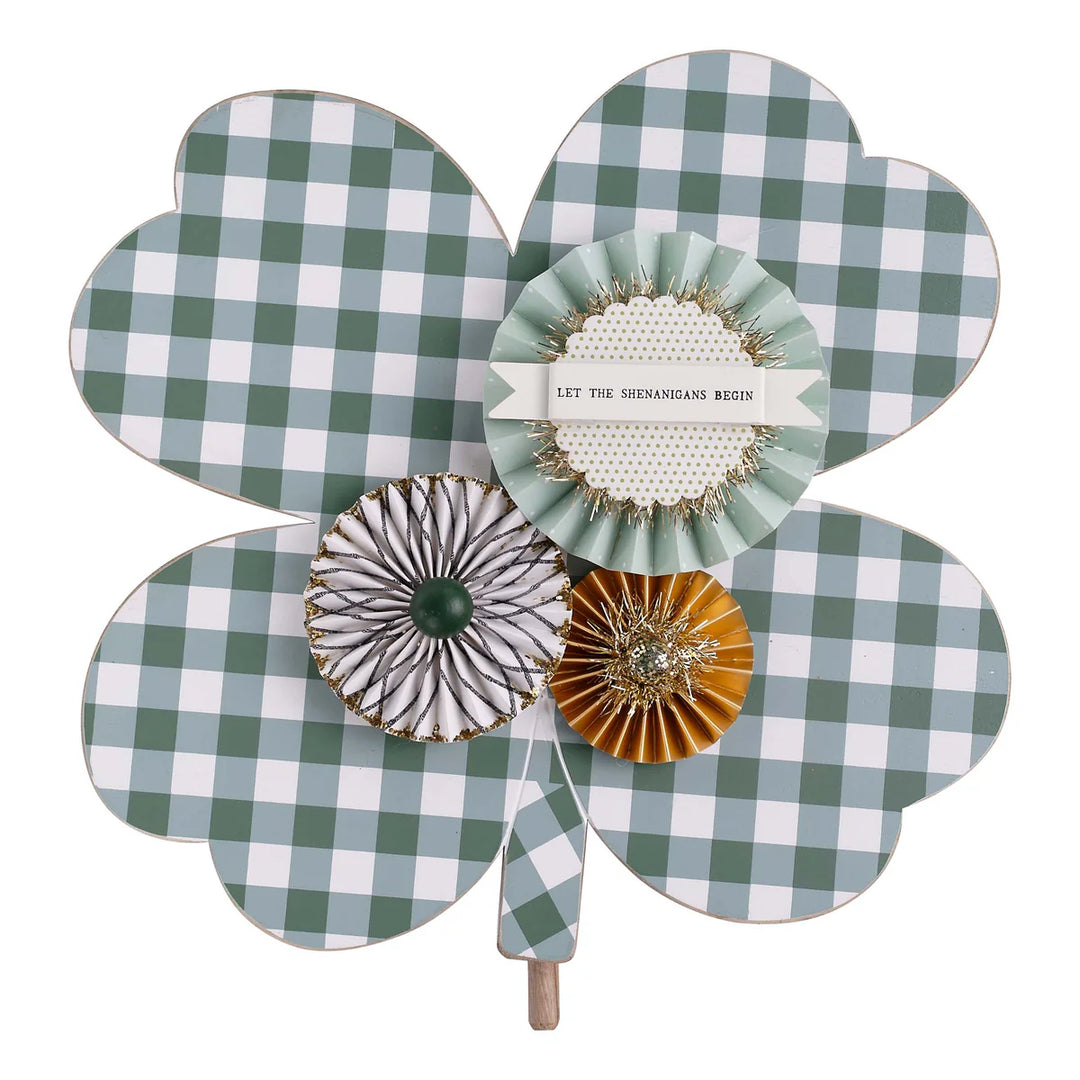 Decorative item with a four-leaf clover design featuring checkered patterns and floral elements.