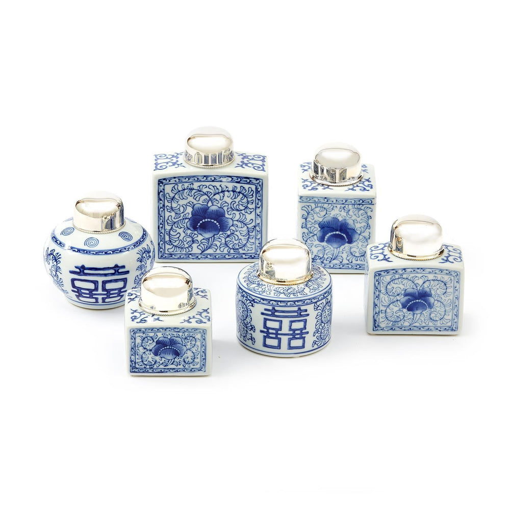 A collection of blue and white ceramic tea jars with silver plated brass tops, hand painted with traditional Chinese patterns.