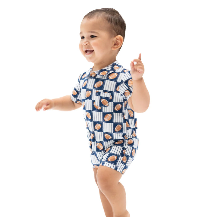 Angel Dear Football Patchwork Polo Shortie worn by a baby in a lifestyle view highlighting the football patchwork design