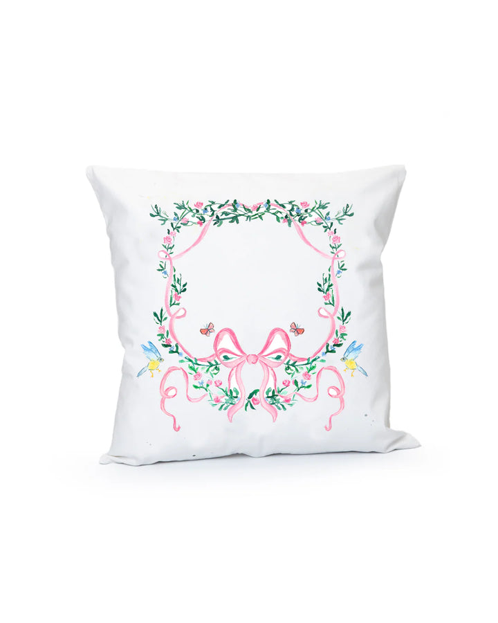 Decorative pillow with floral wreath design on a white background