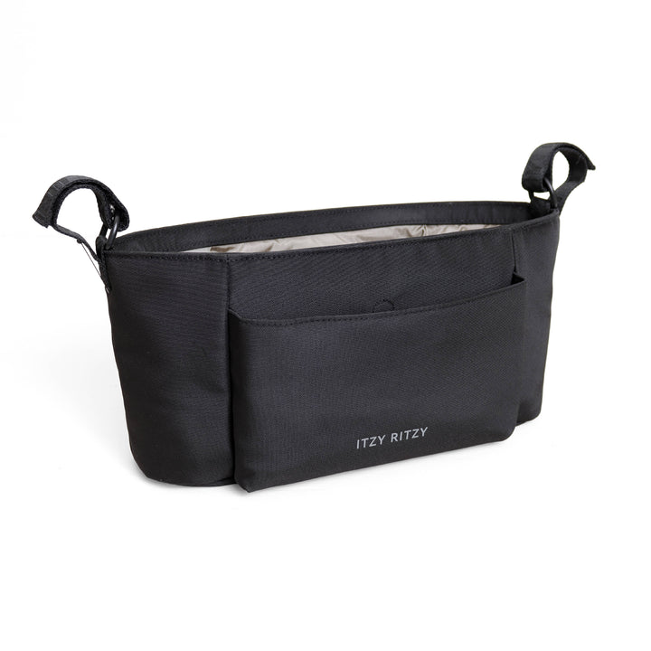 A black diaper bag with a front pocket and side handles, featuring the brand name 'ITZY RITZY' printed in white on the lower front, set against a plain white background.