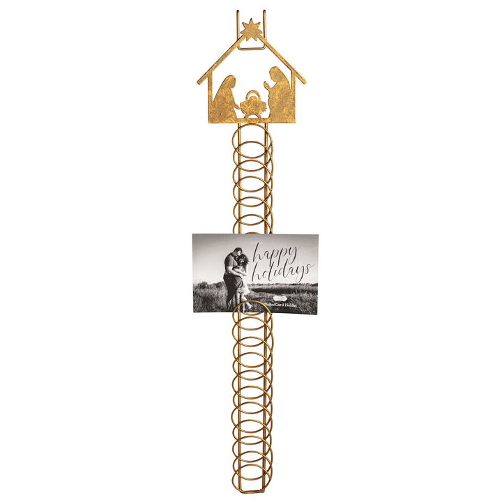 Gold metal coil Christmas card holder features foiled tin Nativity scene topper.