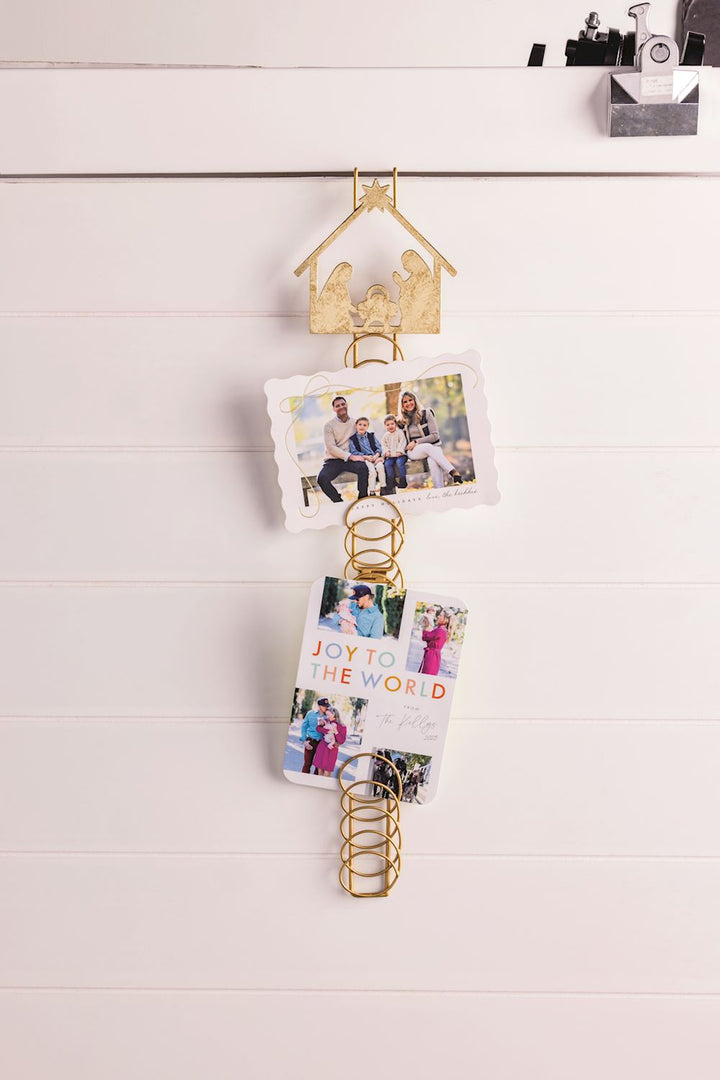 Gold photo holder with cards on a white surface