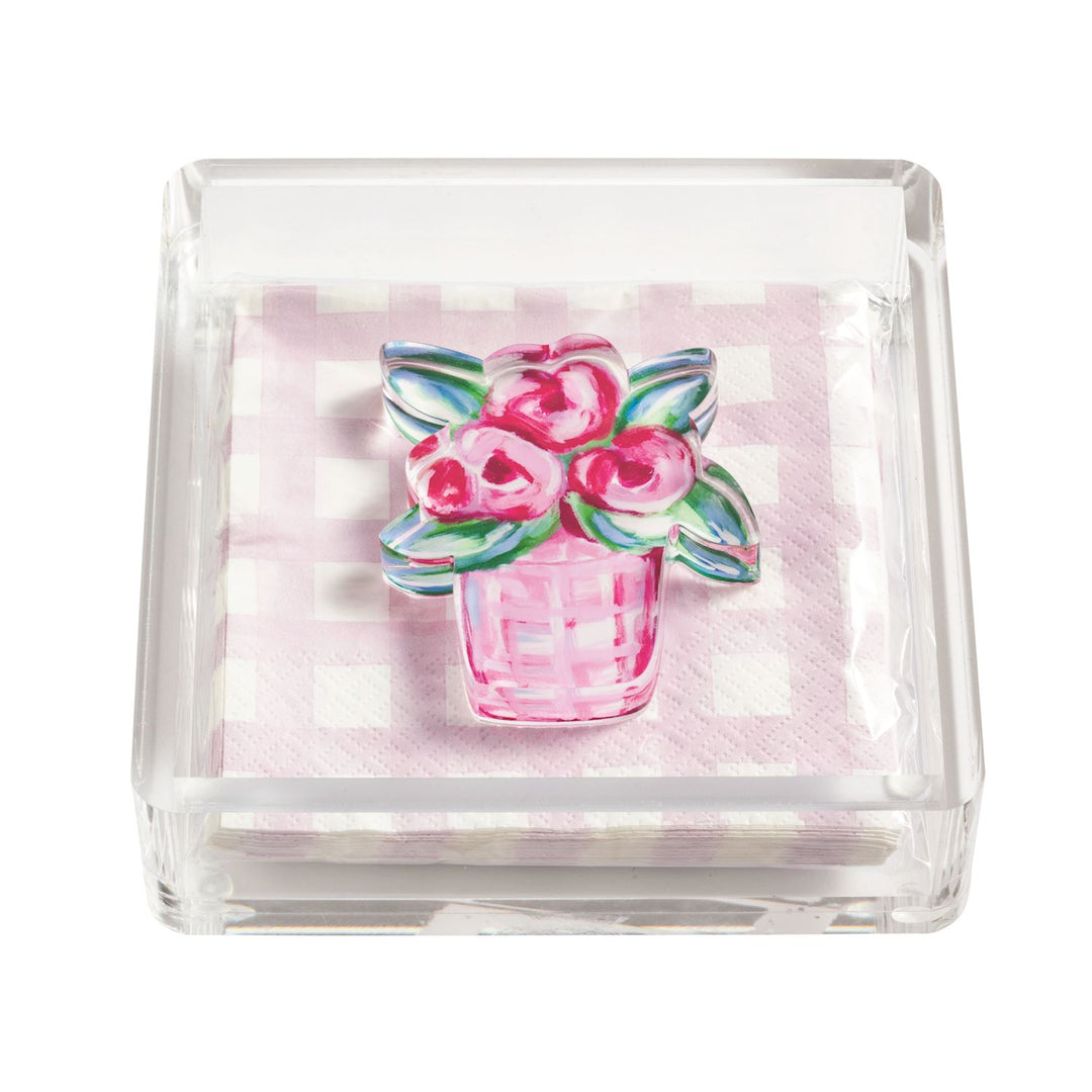 Clear acrylic napkin holder with pink gingham paper napkins and watercolor pink floral bouquet paperweight