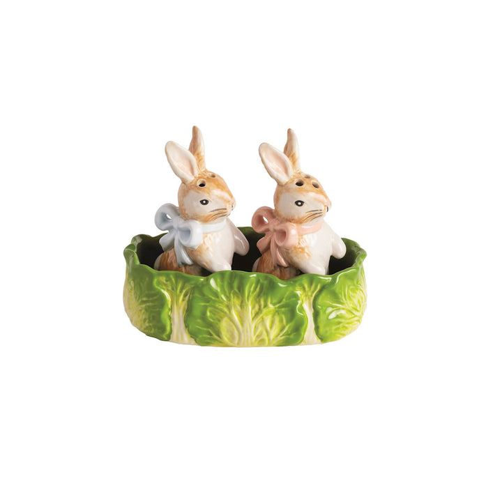 Ceramic bunny salt and pepper shaker set with pastel bow details, nestled in green cabbage leaf holder