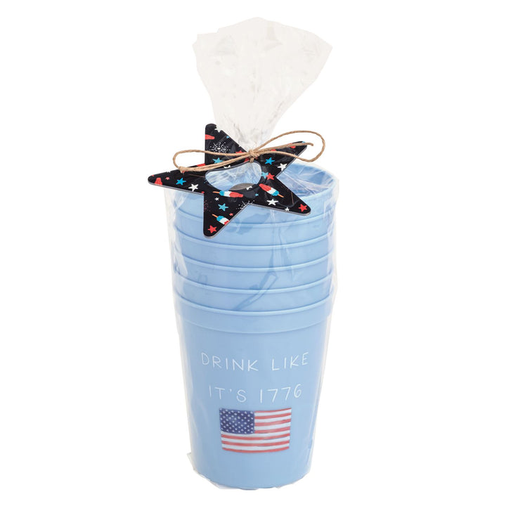 Light blue reusable party cup set with “Drink Like It’s 1776” patriotic lettering and American flag graphic, wrapped in cello with festive star bottle opener