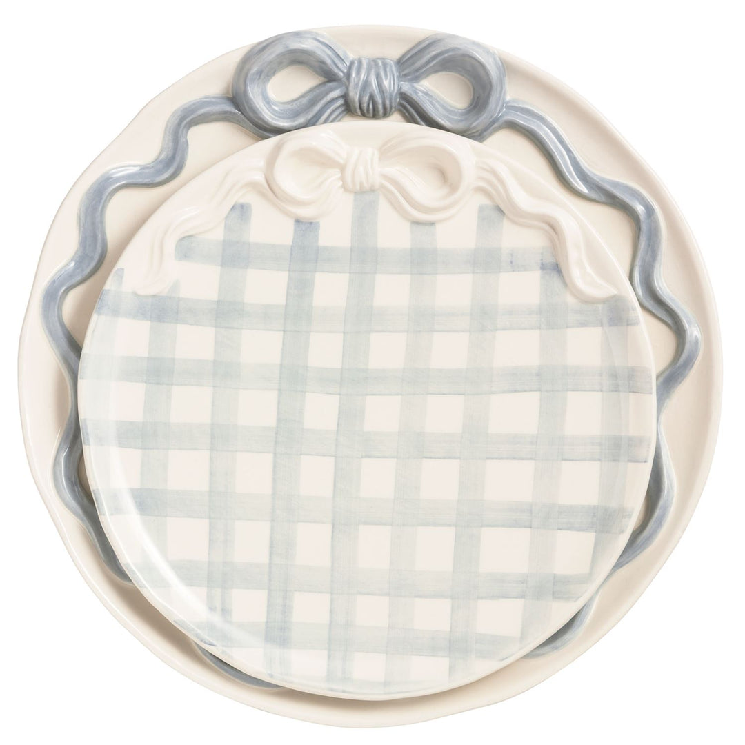 Blue and white gingham pumpkin-shaped ceramic serving platter with sculpted bow detail and scalloped trim