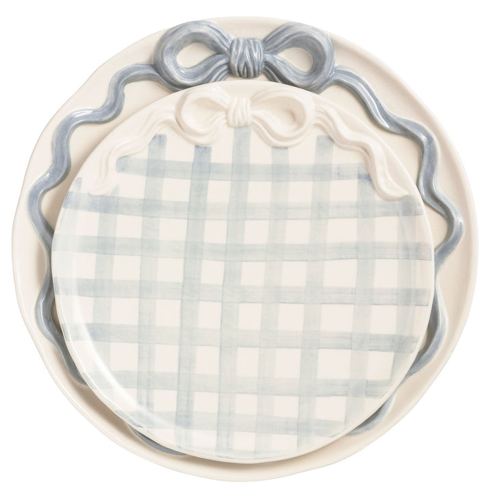 Blue and white gingham pumpkin-shaped ceramic serving platter with sculpted bow detail and scalloped trim