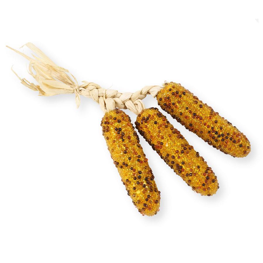 Three corn on the cob with a textured surface on a white background