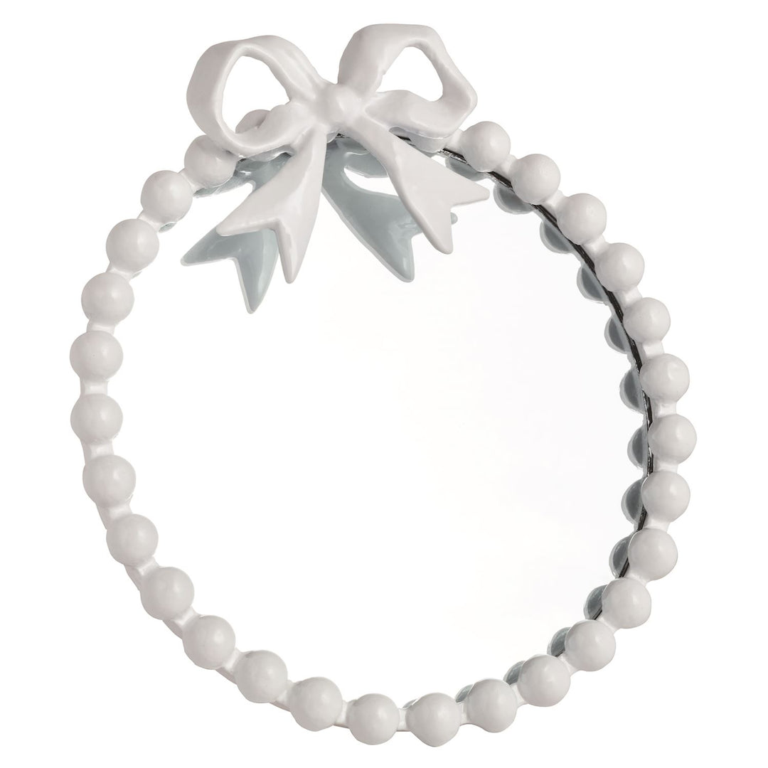 White ball framed mirror with a bow at the top