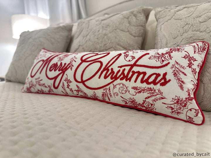 Merry Christmas lumbar pillow on bed