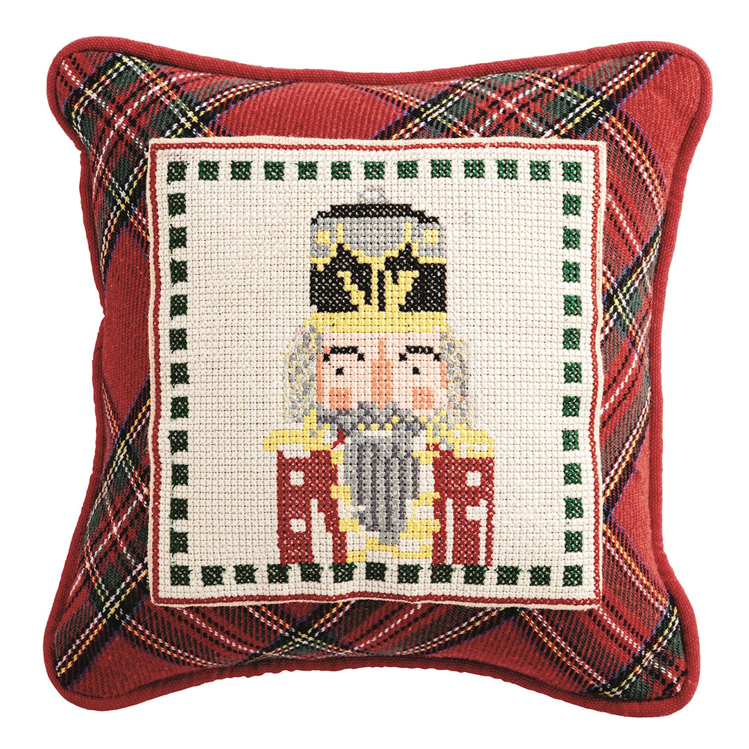 Woven cotton pillow features needlepoint panel and piped edge.
