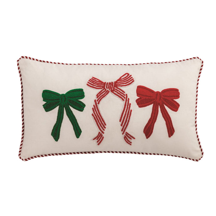 Canvas pillow features crewel embroidery and red and white cord piping. Canvas backing with zipper closure