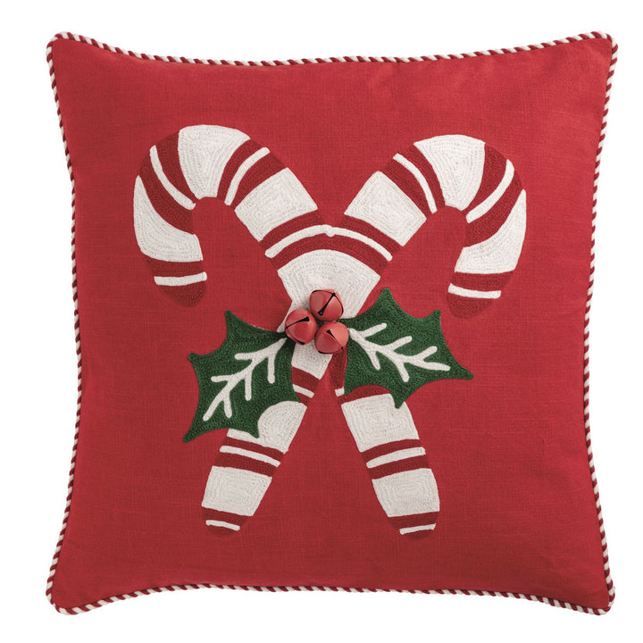 Canvas pillow features crewel embroidery and red and white cord piping. Canvas backing with zipper closure.