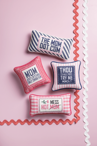 FOUR MOM NEEDLEPOINT STITCHED PILLOWS ON PINK BACKGROUND WITH SCALLOP TRIM
