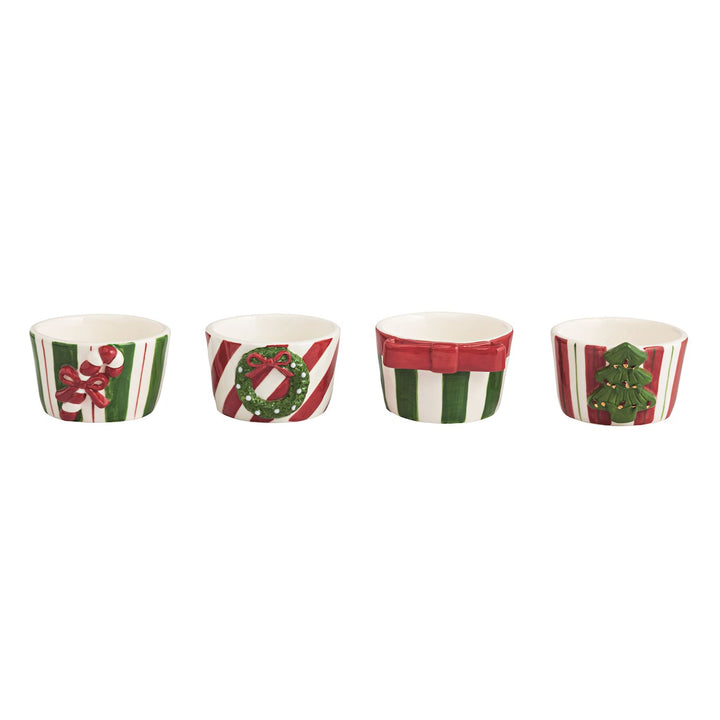 Four Christmas-themed paper cups with decorative patterns on a white background