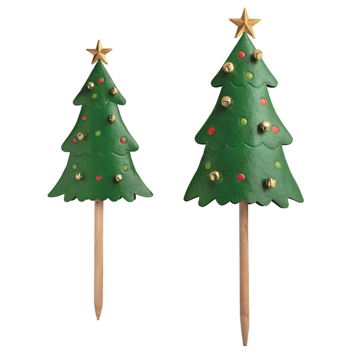 Two Christmas tree-shaped yard stakes with decorative elements on a white background