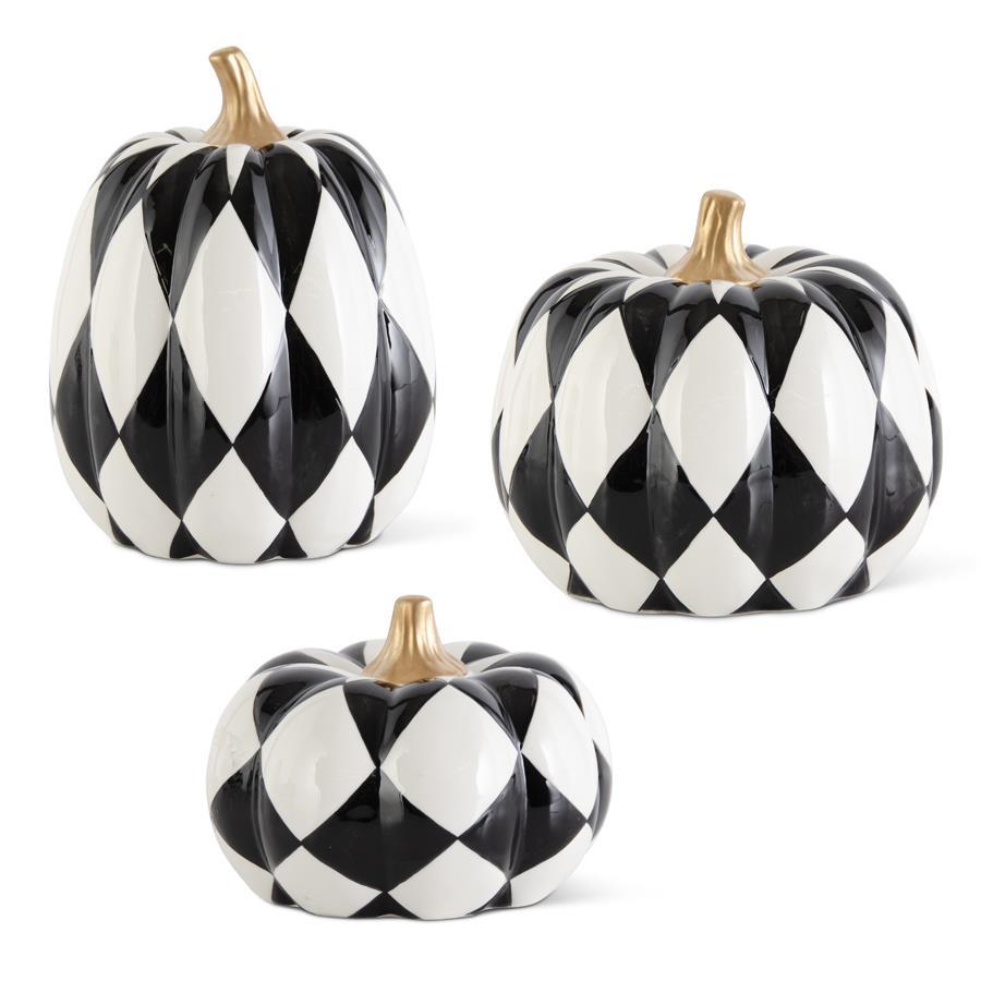 Three black and white checkered pumpkins on a white background